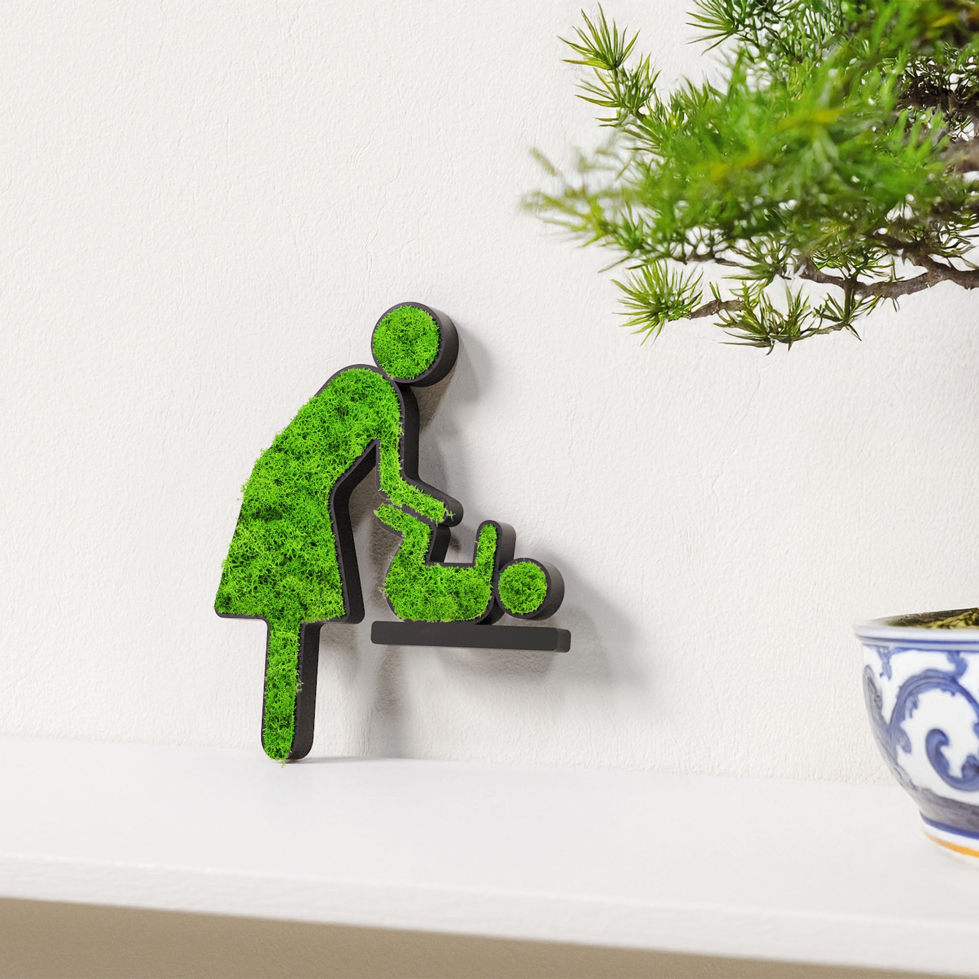 MOOSWERK Moss Door Sign Changing Room Pictogram (Woman & Baby) – Handmade sign with real moss in a black frame